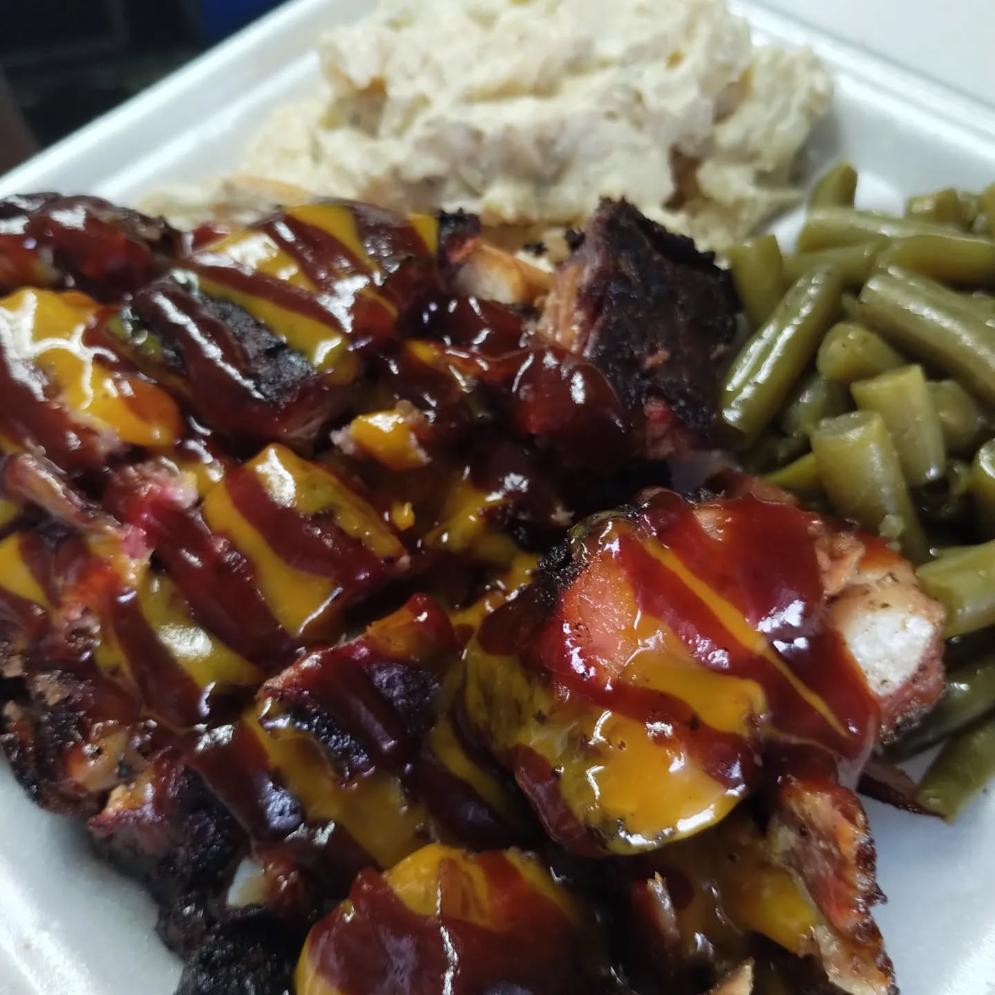 Barbecue spread with ribs, sausage and cornbread