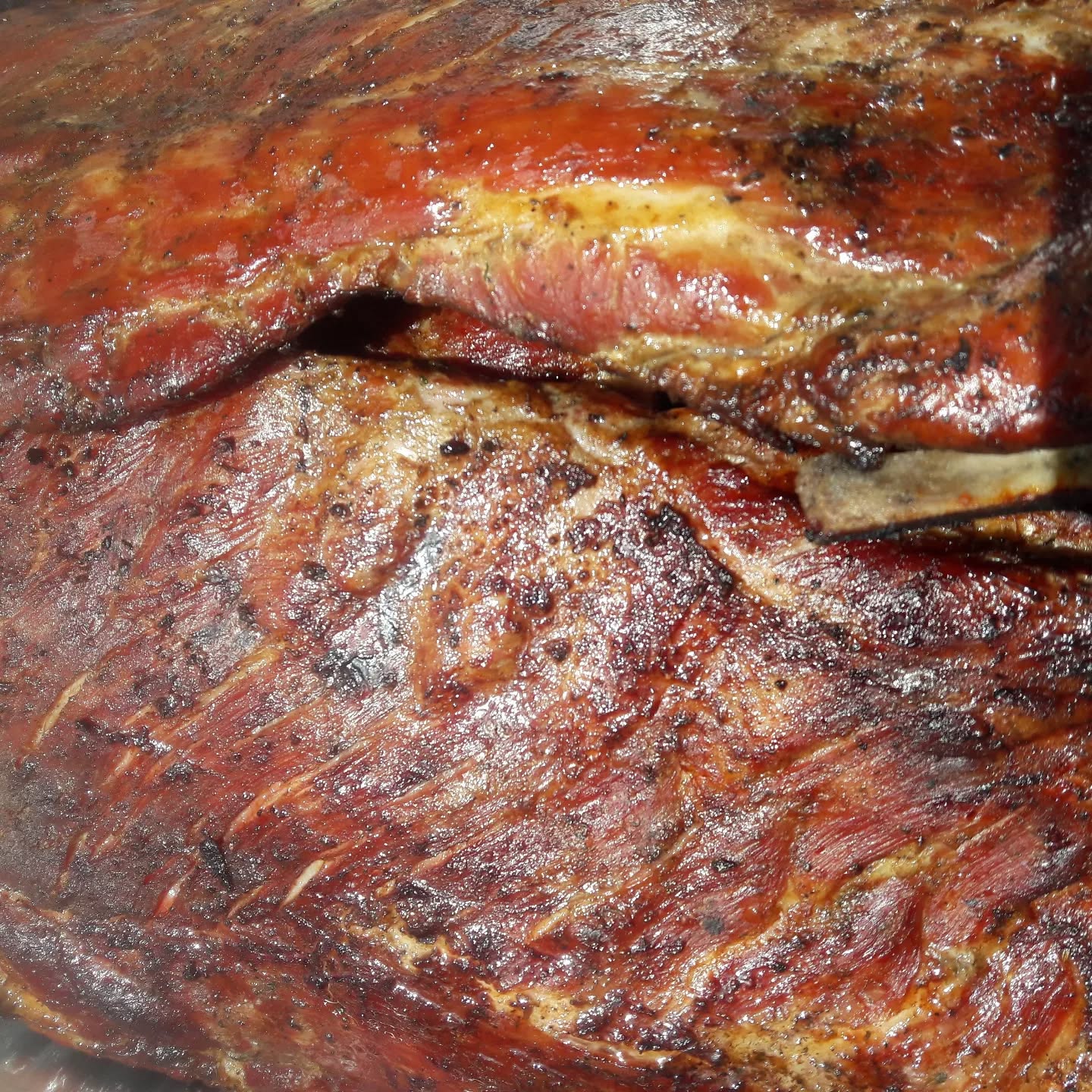 Glazed ribs stacked on a wooden board